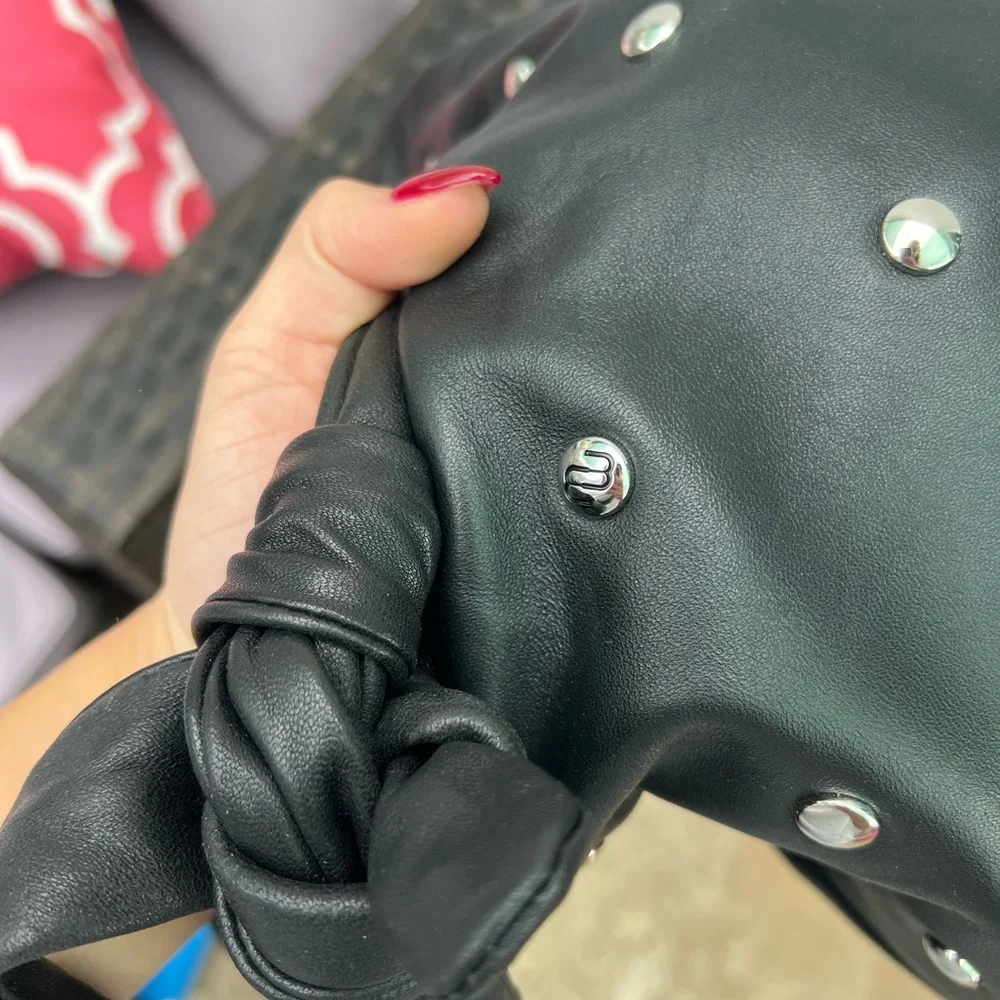 Maje “le bow bag” in black leather with silver studs